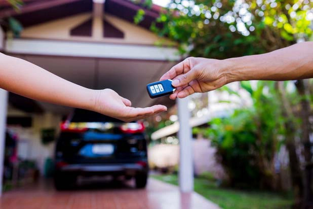 Driver handing over keys to a customer after a delivery.